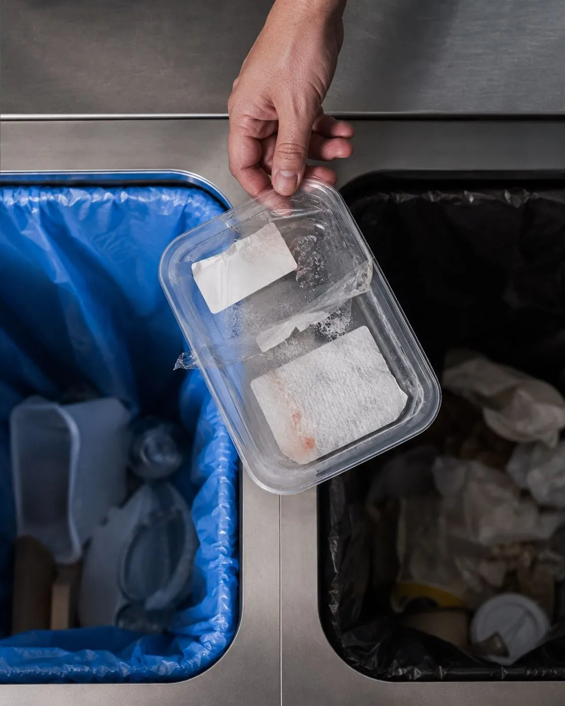 Mixed-material packaging with conflicting recycling symbols