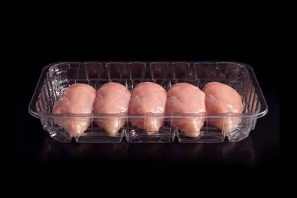 Raw protein in a clear Lucid Infinity tray on black