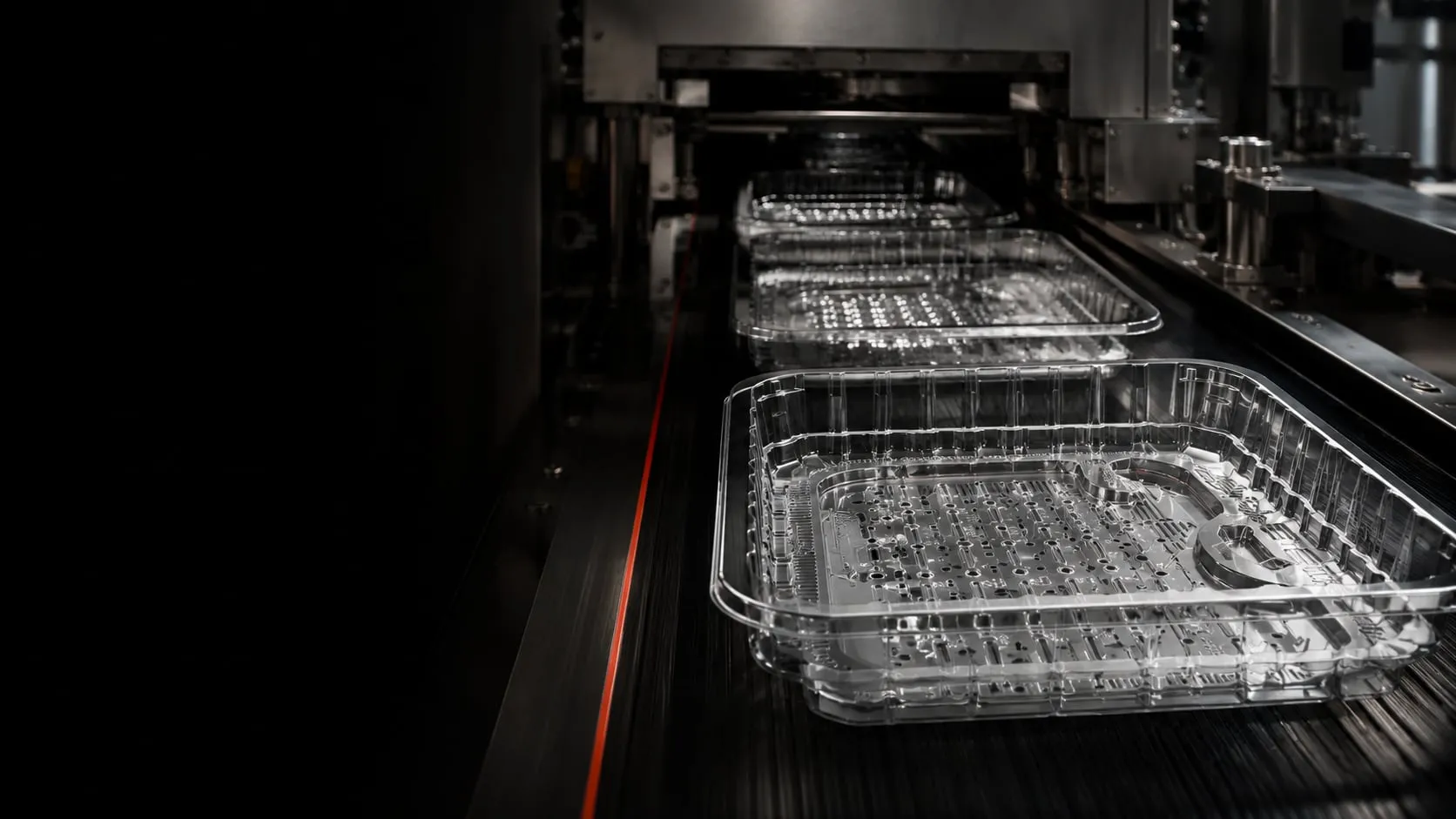 Infinity trays moving along the forming line in low light